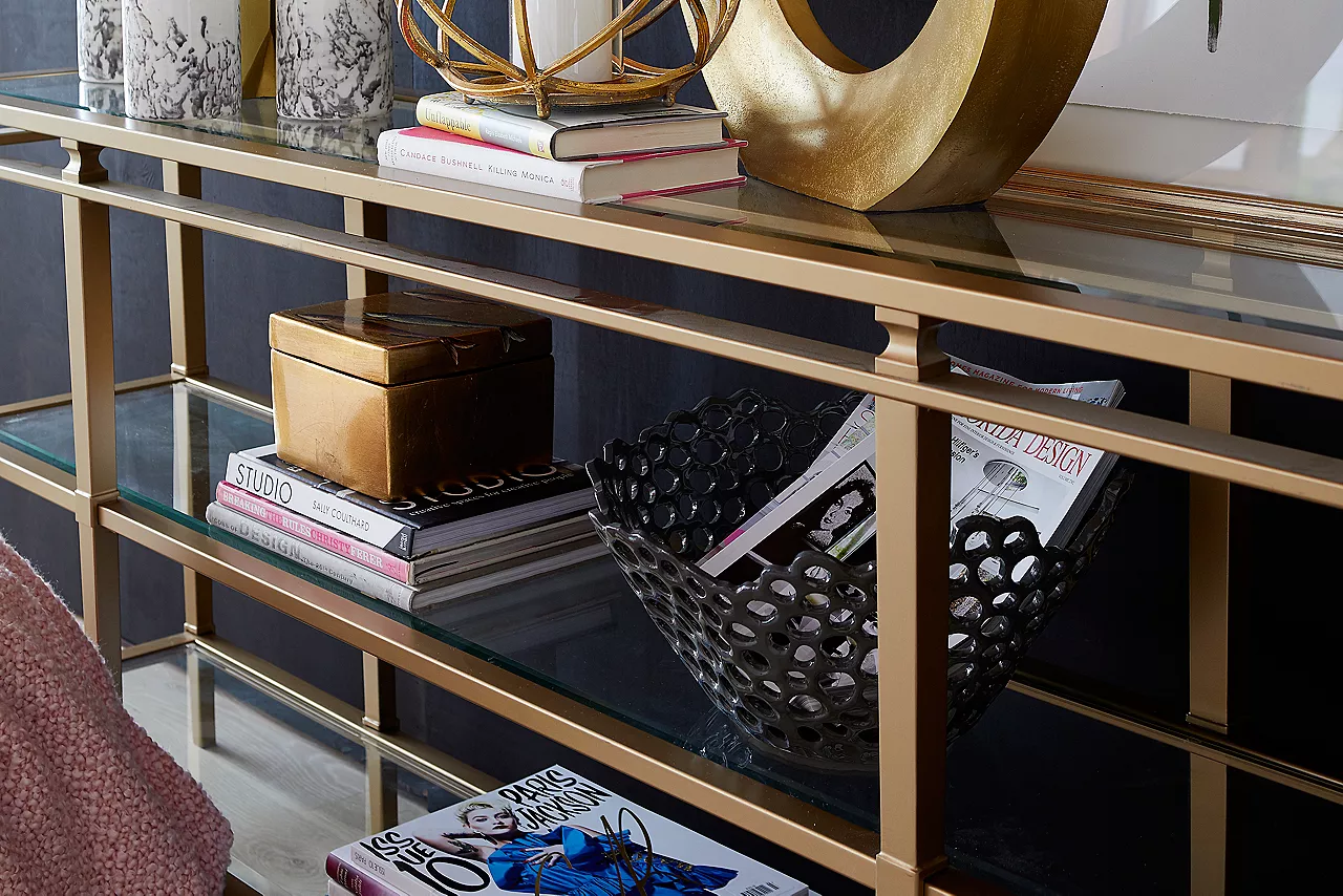 The Amani glass and gold finish sofa table in room scene.